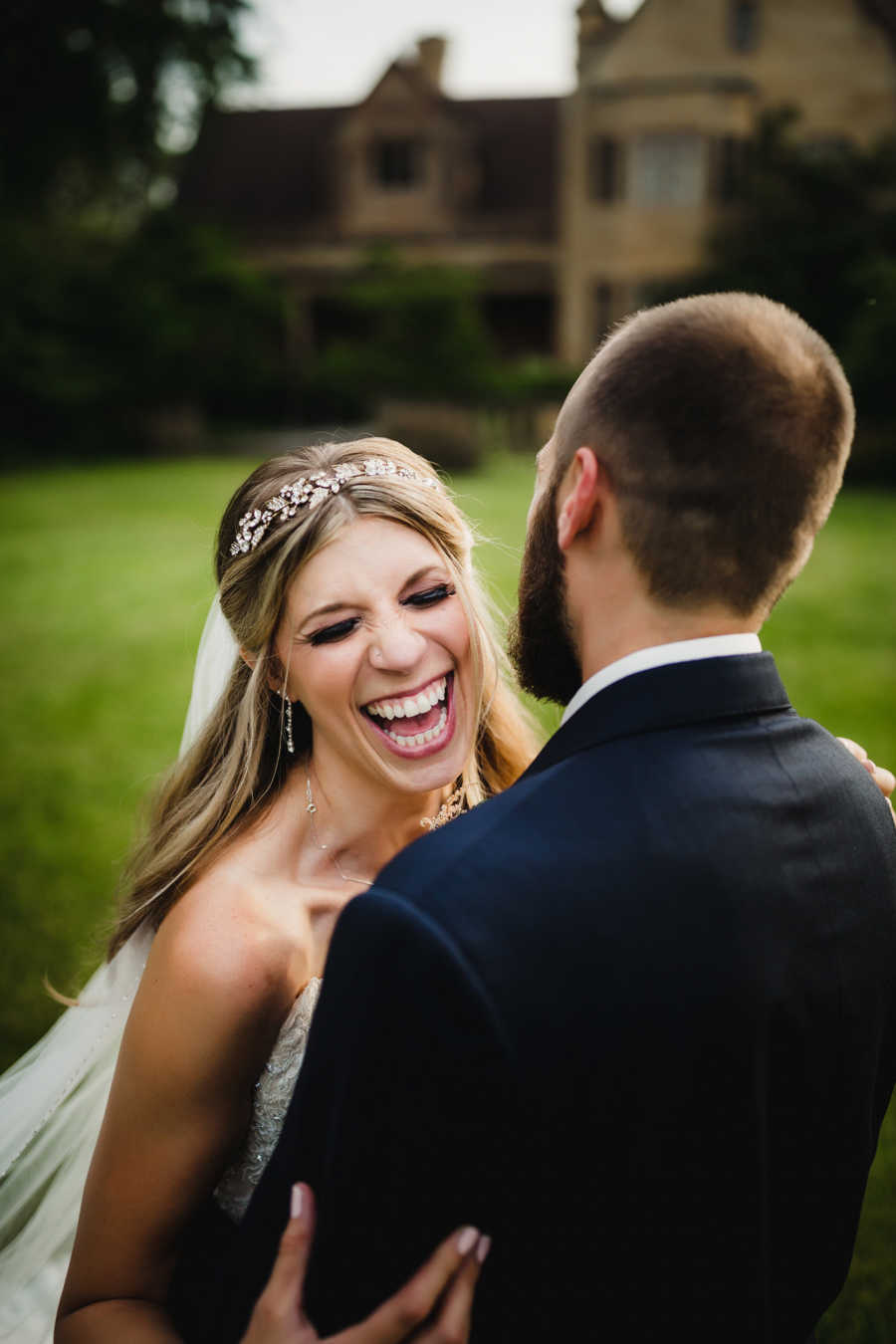 Woman laughs during candid moment during wedding photoshoot with her new husband