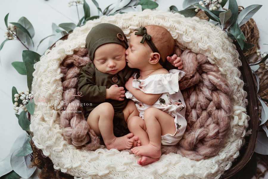 Boy and girl twins snuggle during a newborn photoshoot