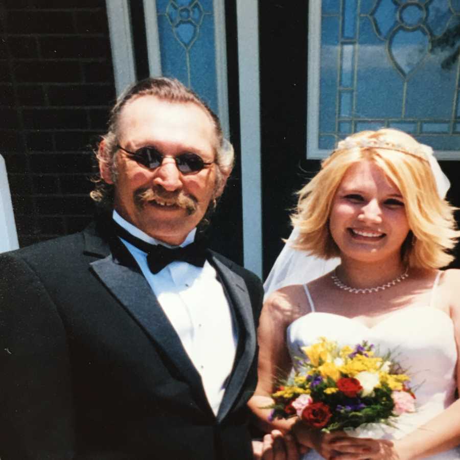 Woman stands next to her stepdad on her wedding day