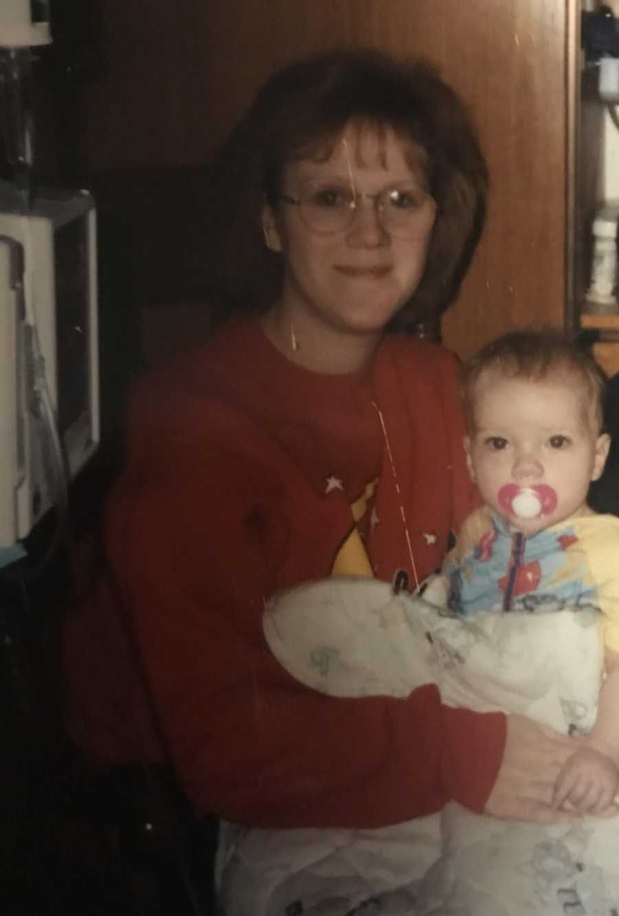 Mom and toddler daughter smile for a photo together while in the hospital