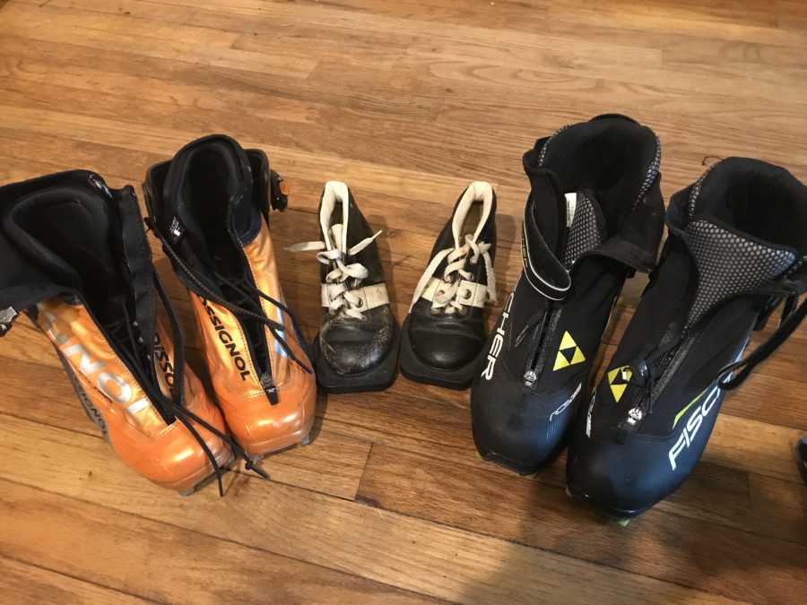Woman takes a photo of a bunch of hiking shoes