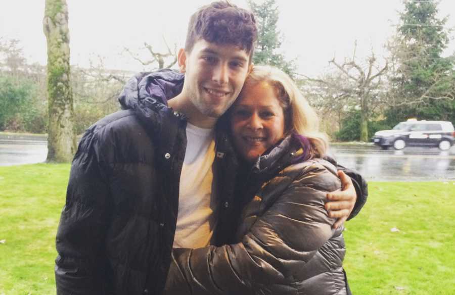Mother hugs teen son outside who has recovered from drug use