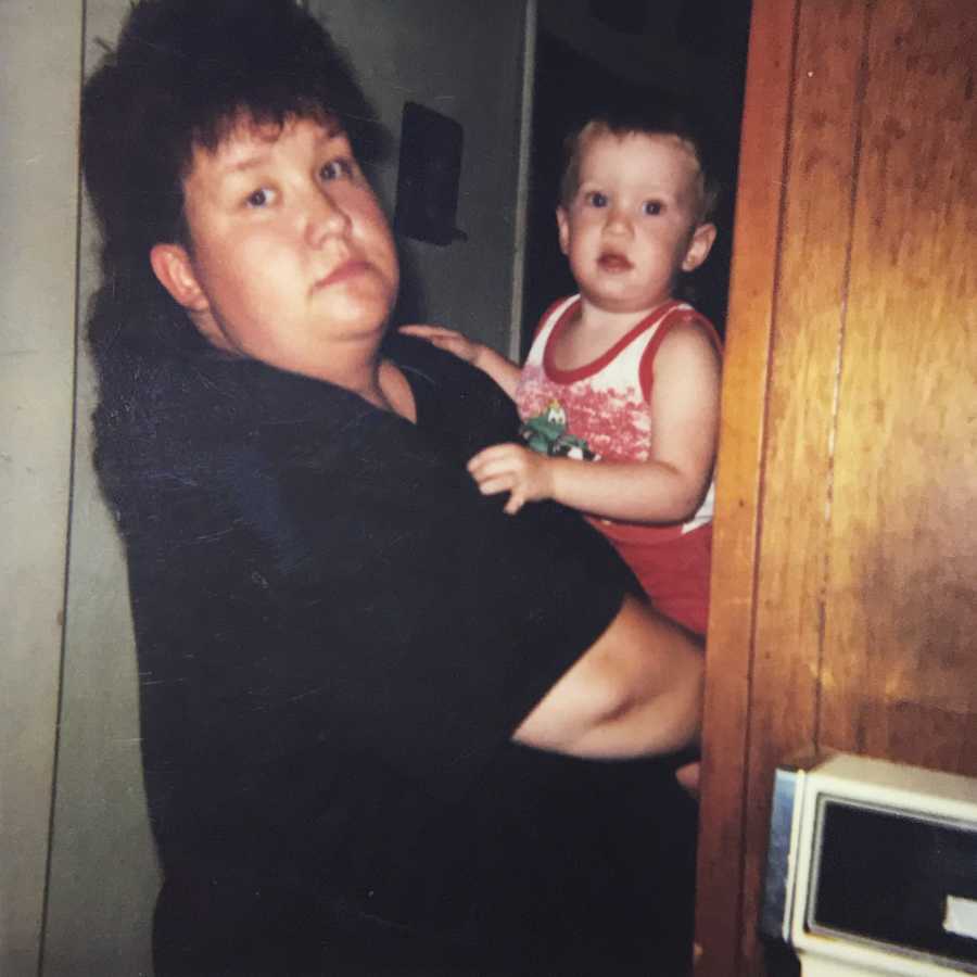 Mom with mullet haircut holds her toddler son