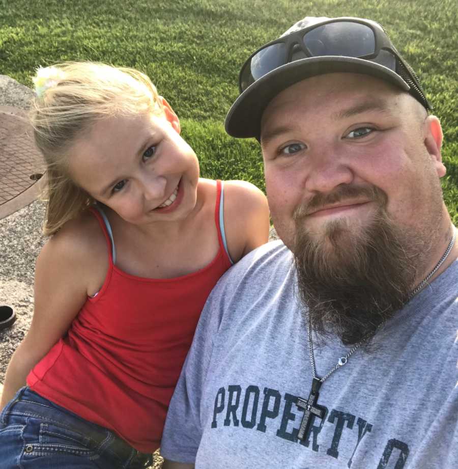 Father takes a silly selfie with his daughter while enjoying a day at the park