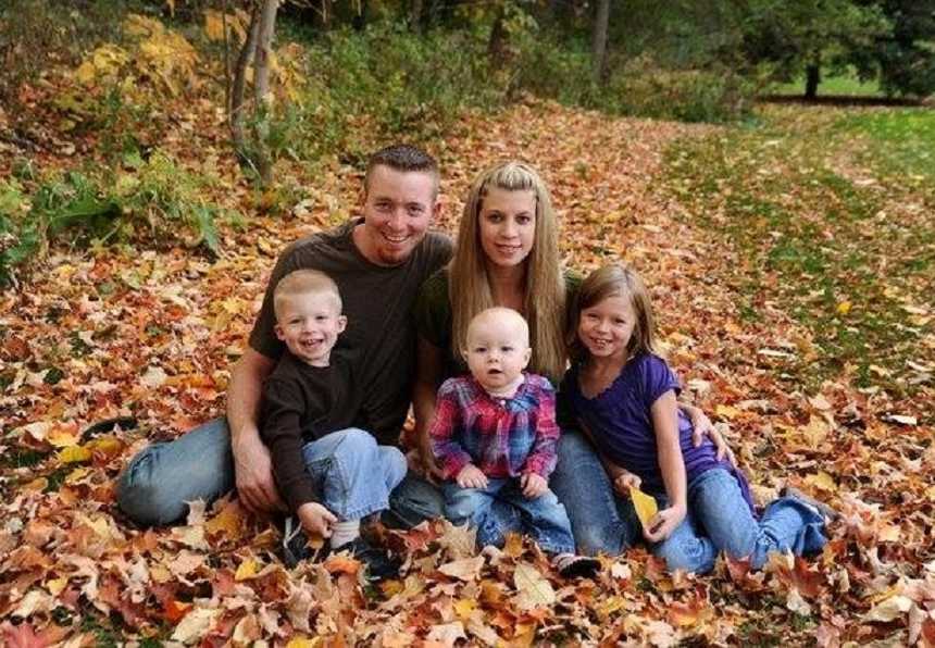 Young couple take fall-themed photos with their three kids