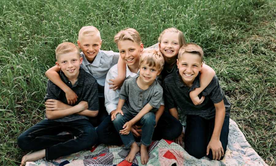 Step-siblings smile while taking a group photo together