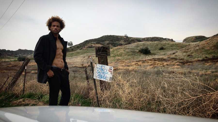 Muscular man looks serious during a desert photoshoot