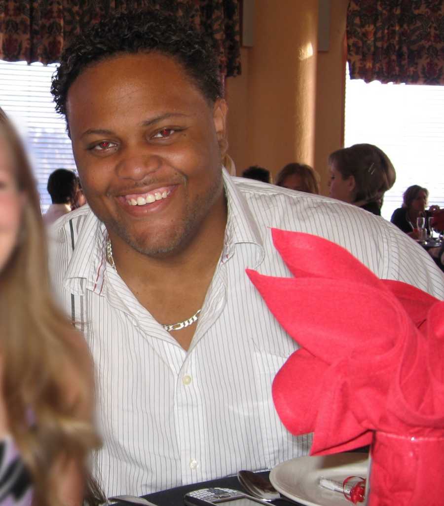 Man battling weight issues smiles for a photo at an event