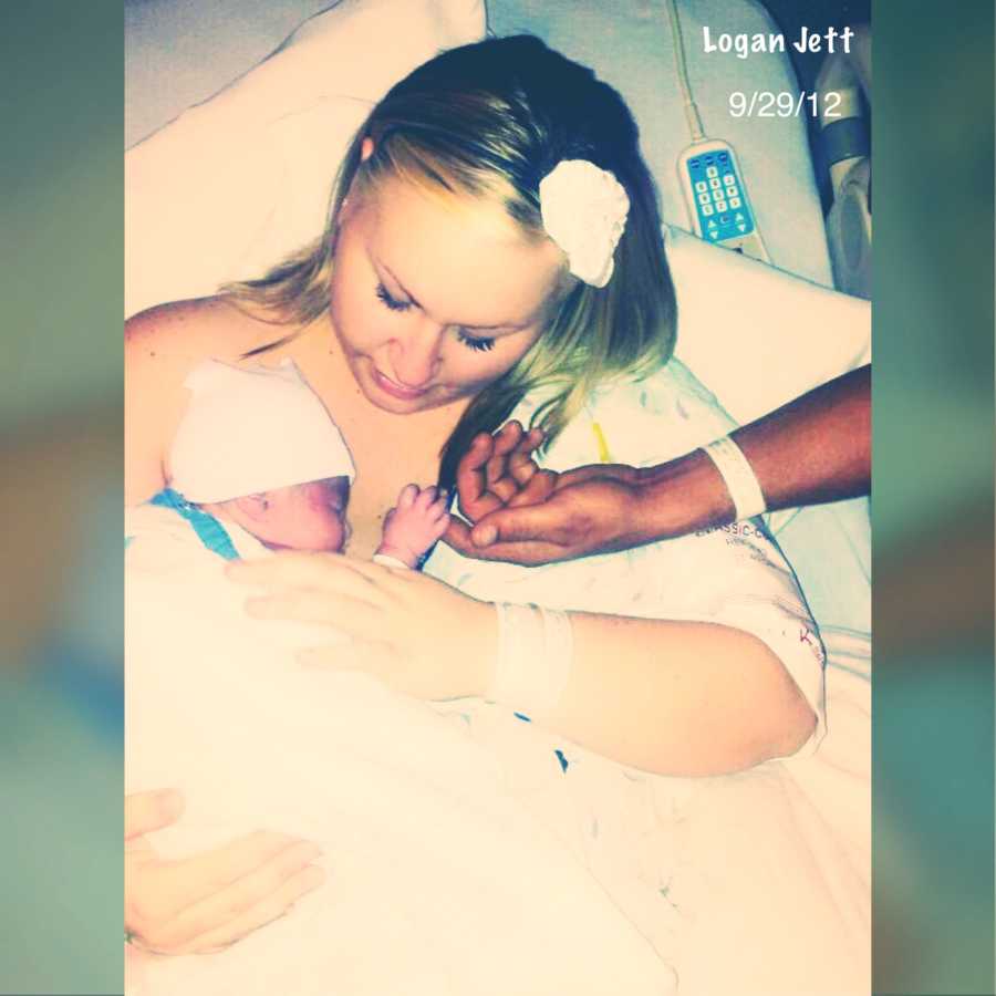 Mom holds newborn son in the hospital after delivering him