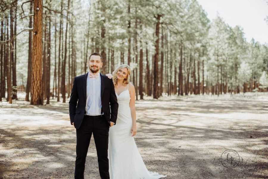 Bride in white dress touching groom's shoulder