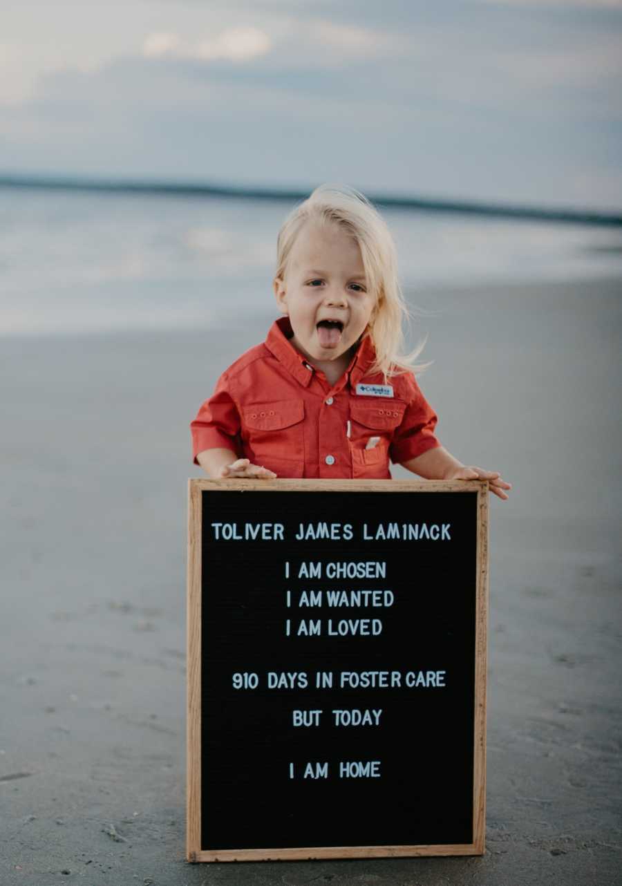 Little kids takes photos on the beach to announce their adoption