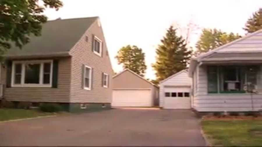 Woman snaps a photo of her house and her neighbor's house after finding out her neighbor is her long-lost sister