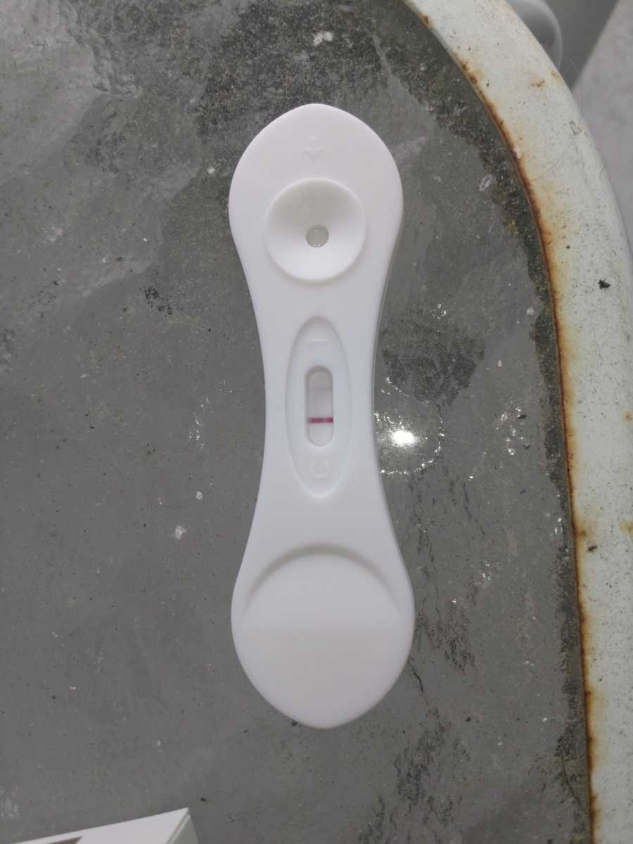 Woman takes a photo of a negative pregnancy test