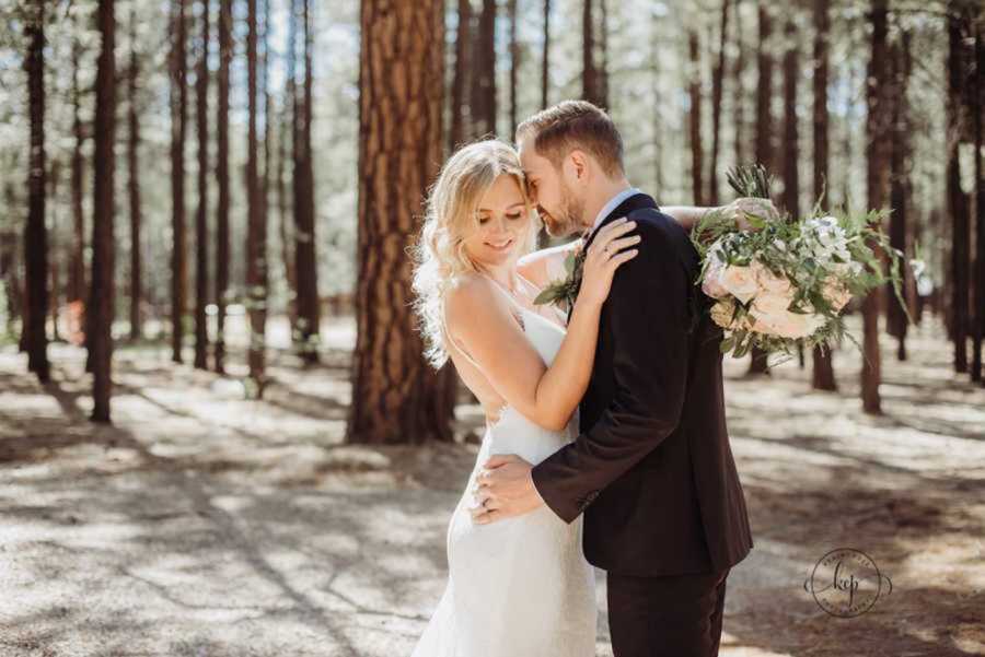 Bride and groom holding one another