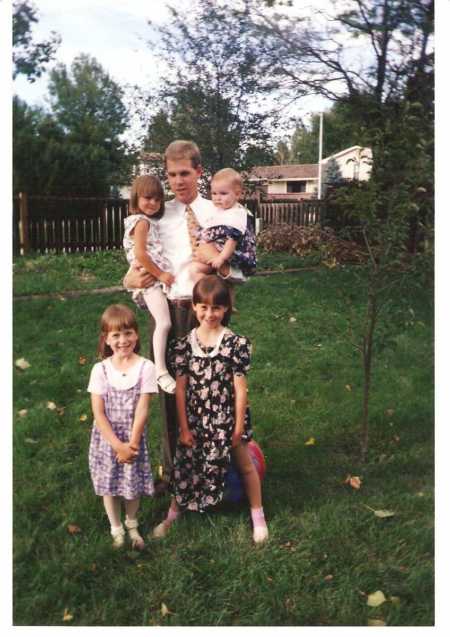 Father takes a photo with his four daughters before church