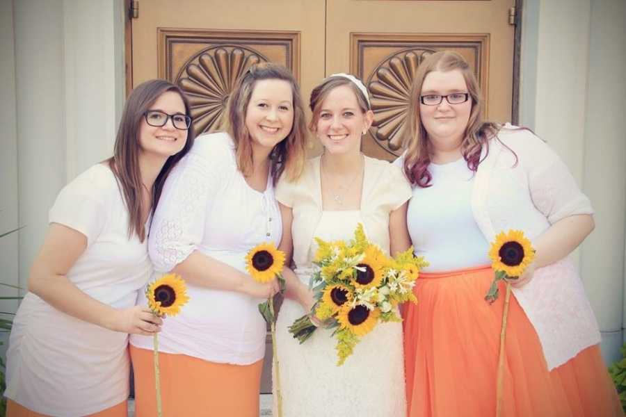 Sisters smile together on one of their wedding days