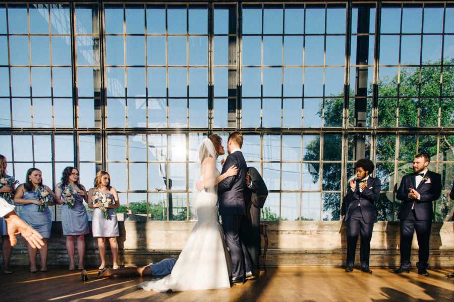 Wedding party look shocked after maid of honor, bride's sister, falls to the ground and faints