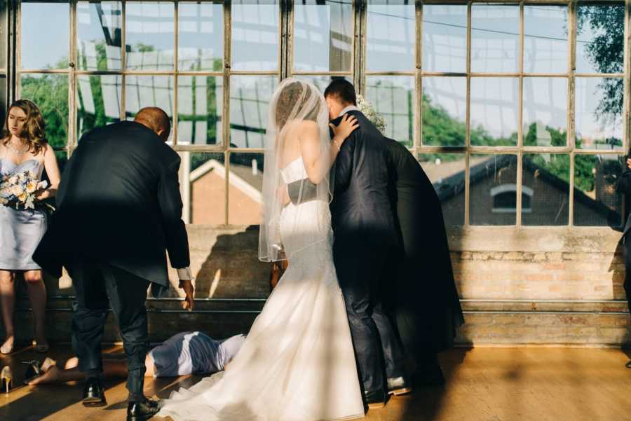 Father of the bride attempts to pick up fainted maid of honor