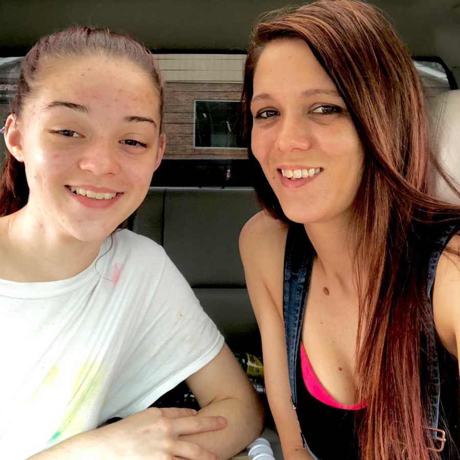 Mom and daughter take selfie together while sitting in a car