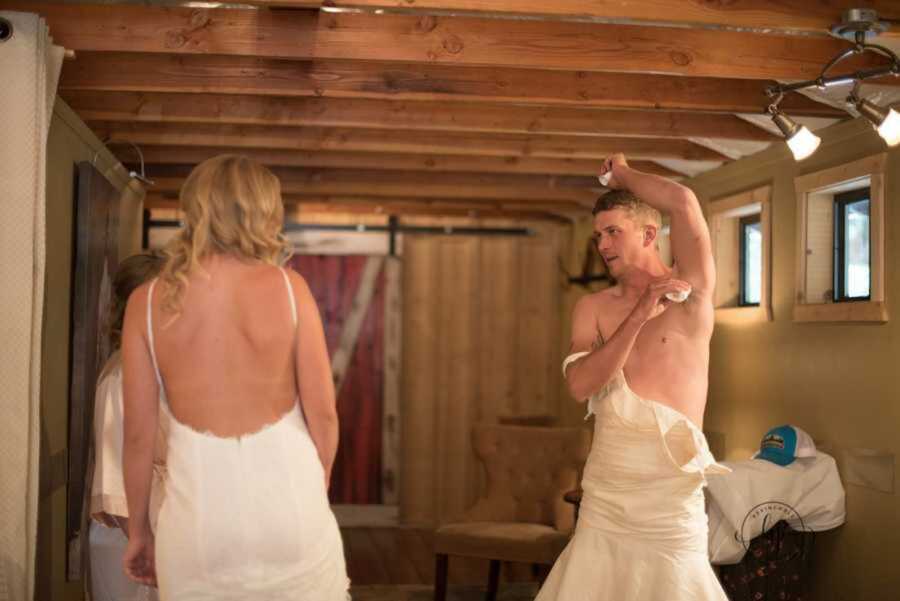 Man in wedding dress applying deodorant