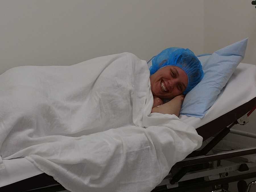 Woman battling infertility smiles before going in for a procedure