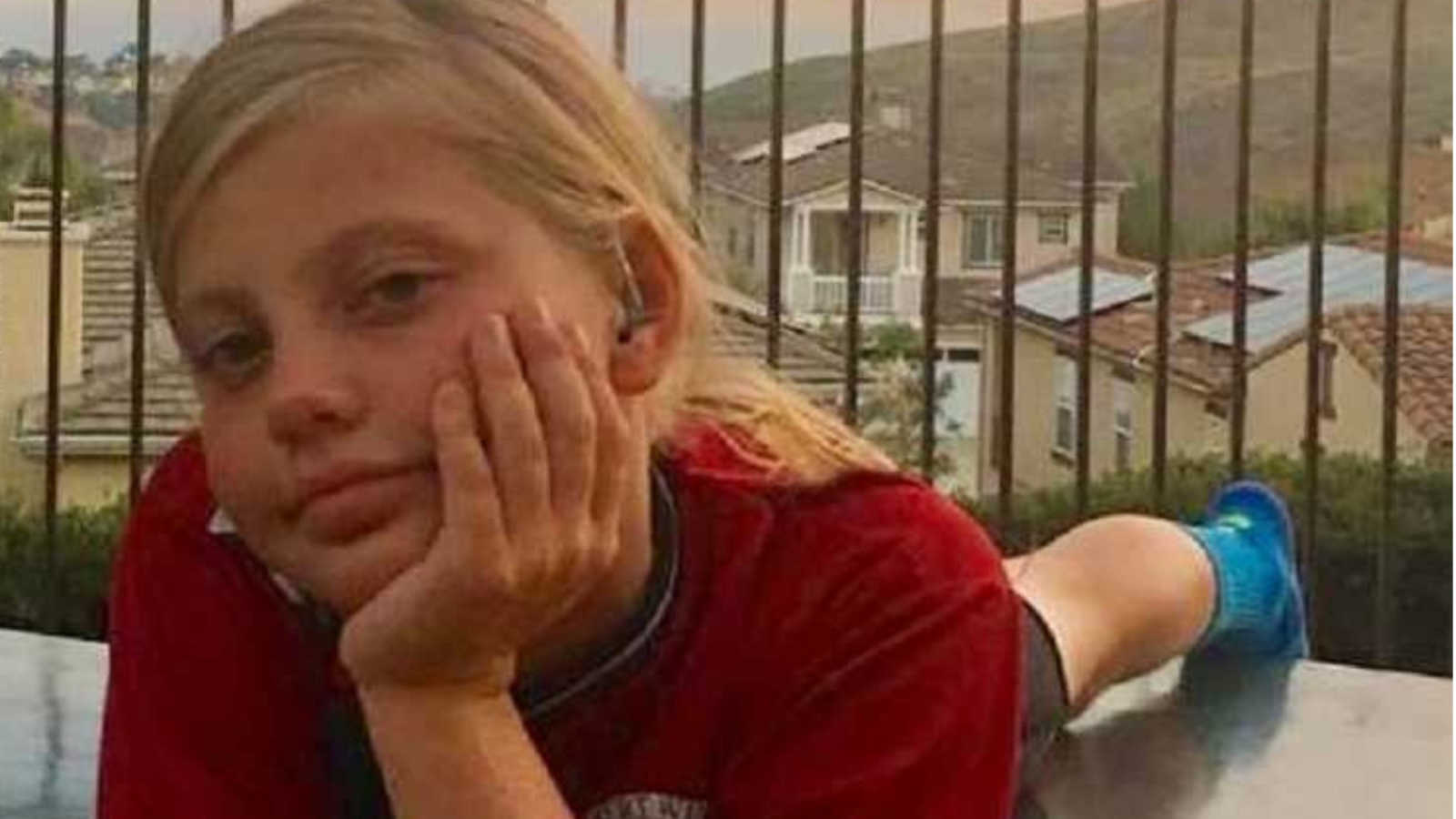 Mom takes photo of tomboy daughter lying the floor of a balcony