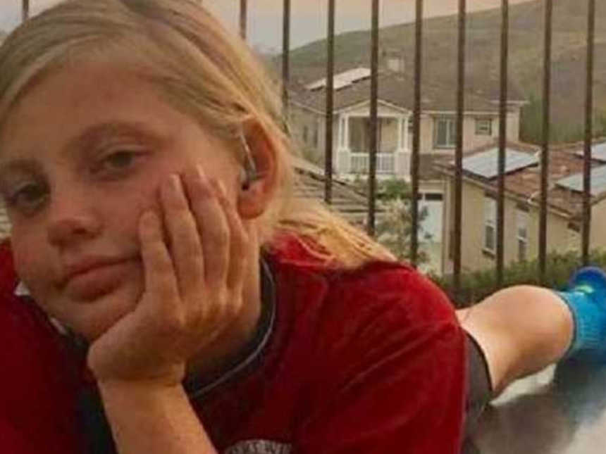 Mom takes photo of tomboy daughter lying the floor of a balcony