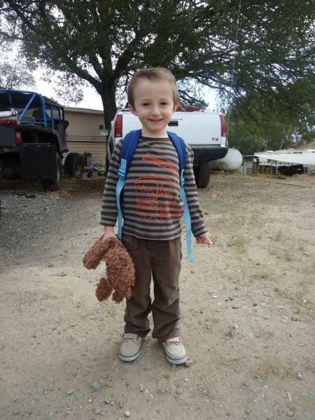 Little boy holding stuffed animal with backpack on whose mother had him when she was seventeen