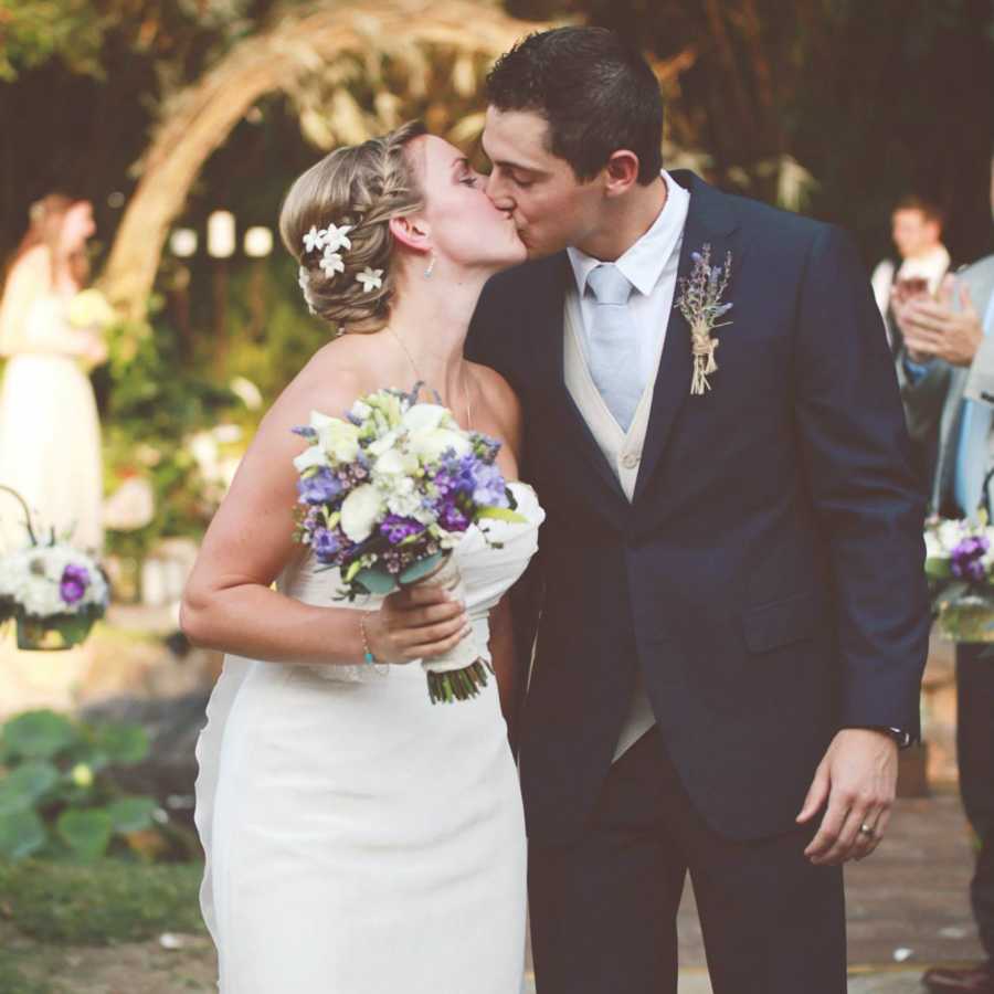 Bride and groom kissing at wedding