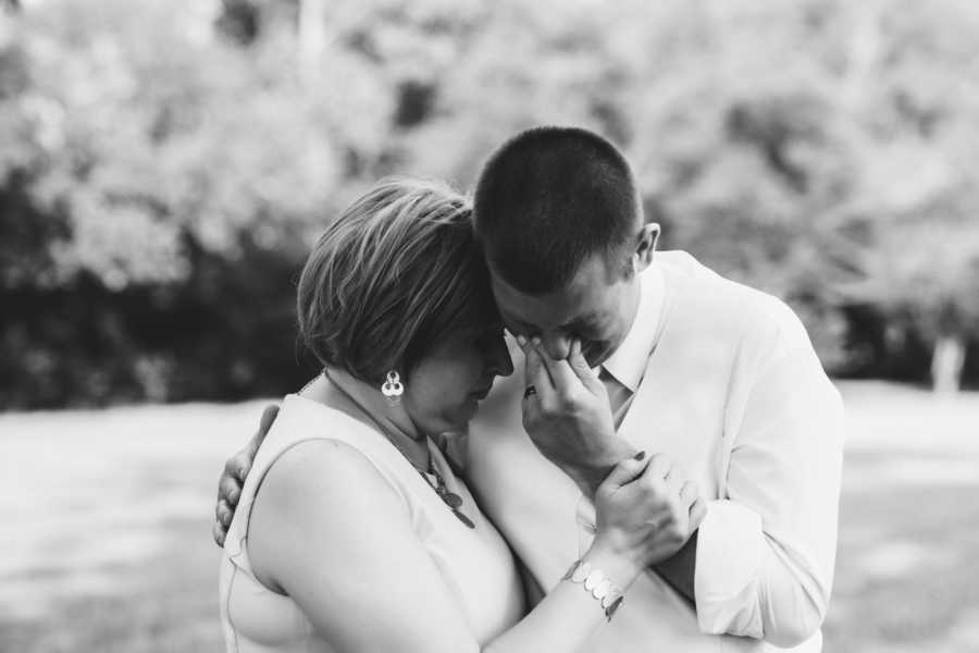 Mother with breast cancer holds oldest son who is crying at his wedding