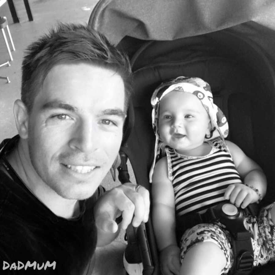 Father who was told he was a great dad and didn't know how to respond smiles in selfie with infant in stroller