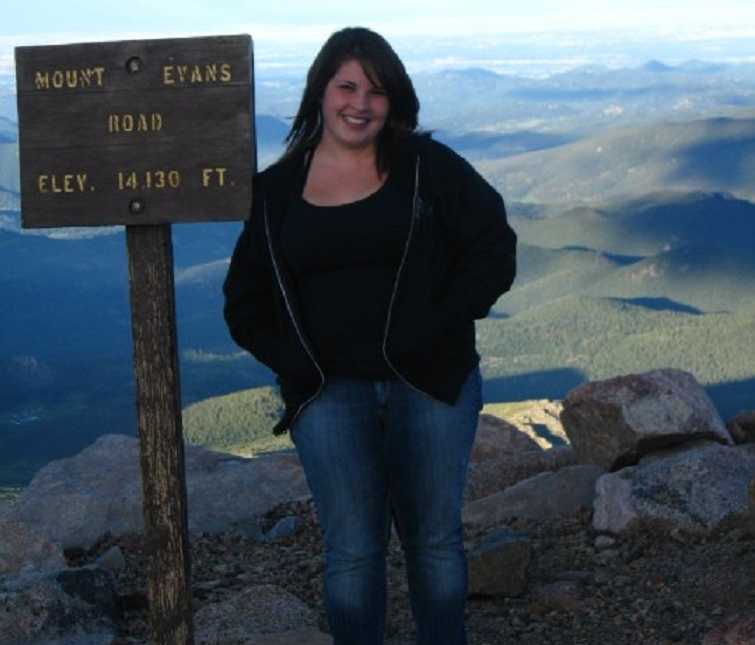 Woman who turned to intermittent fasting as an overweight teen standing on Mount Evans