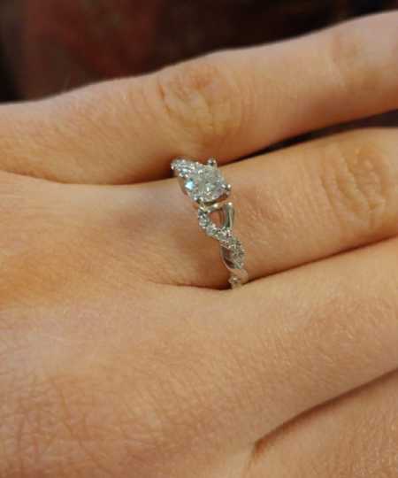 Close up of engagement ring on woman's finger who will find out fiancee isn't who she thinks