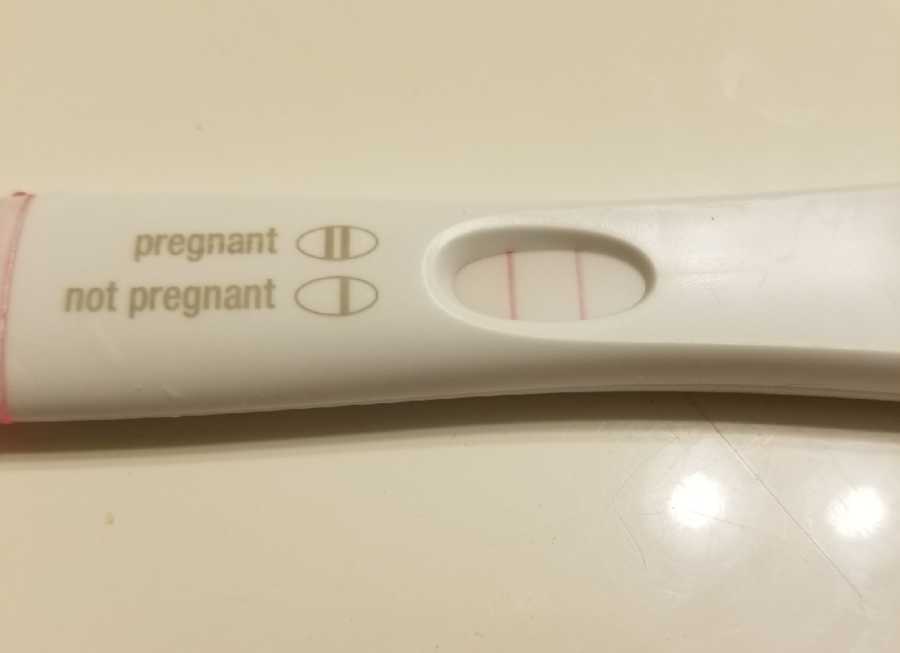 Pregnancy tests indicating woman who had trouble getting pregnant with third child is pregnant
