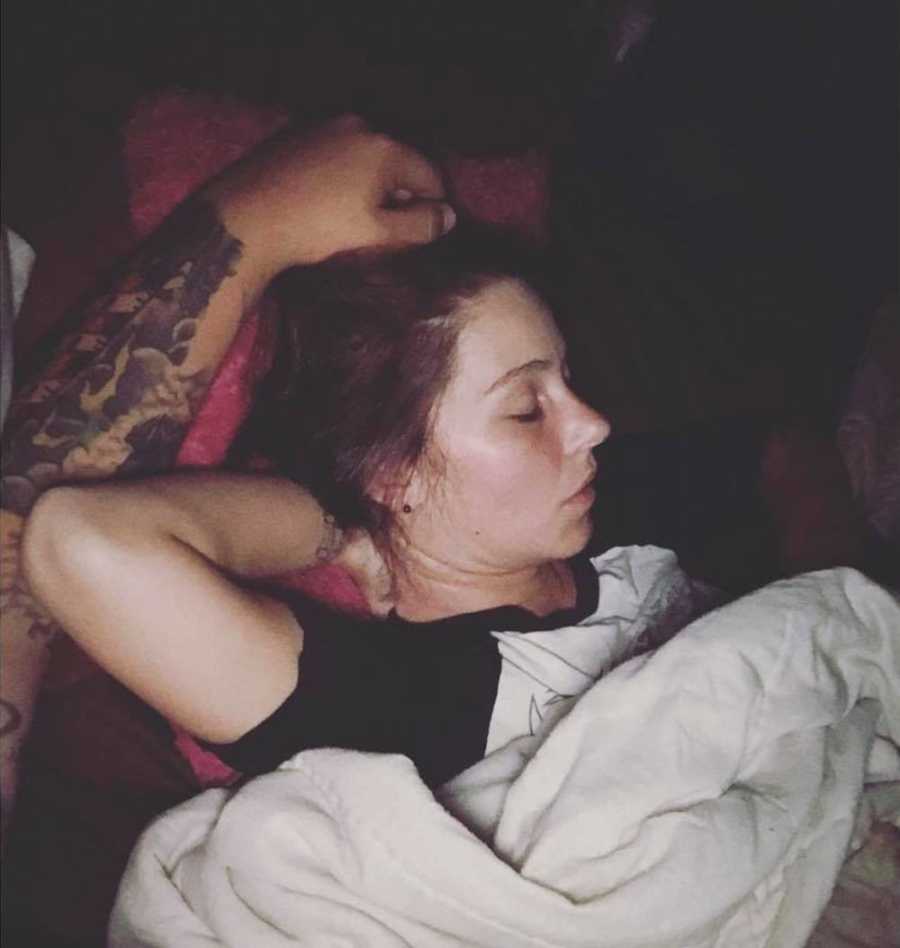 Husband with hand on wife's head as she admires how beautiful she is when she sleeps