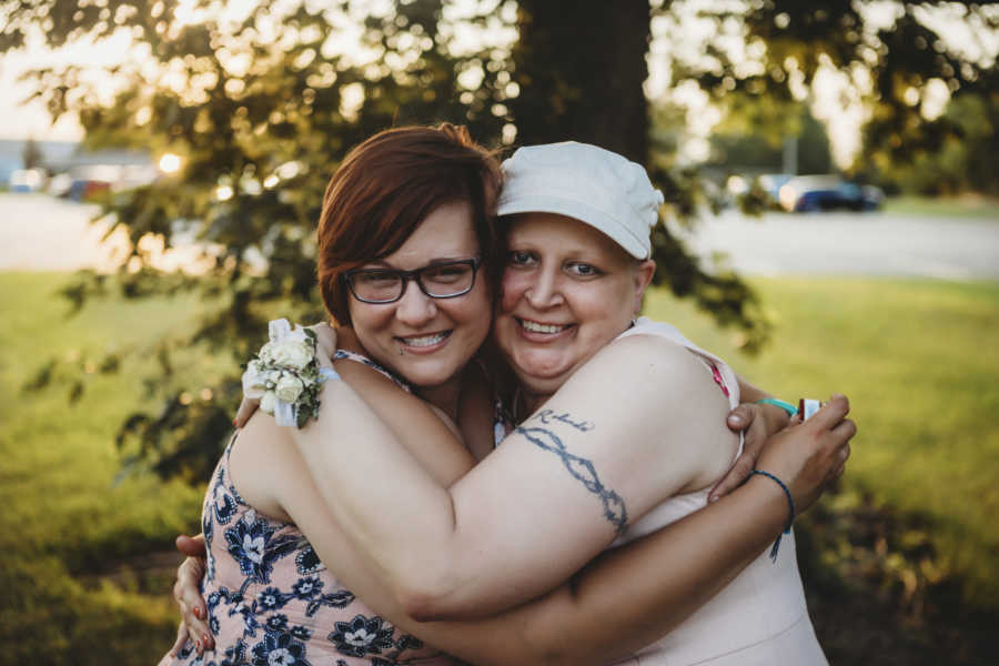 Mother with breast cancer hugs daughter