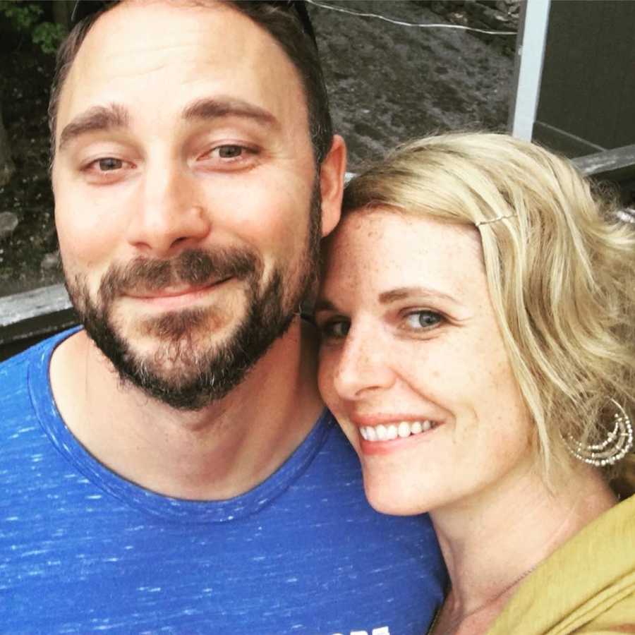 Woman who misses who she and her husband were in high school smile in selfie with husband