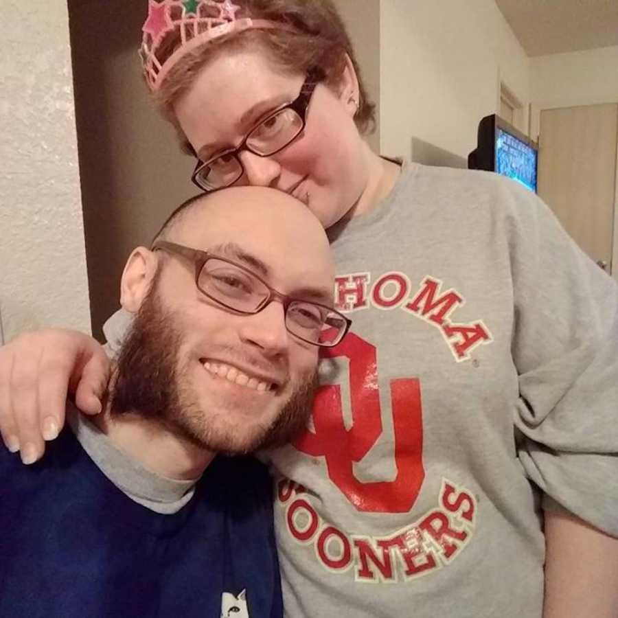 Husband with crohn's disease smiles in selfie with epileptic wife who kisses him on head