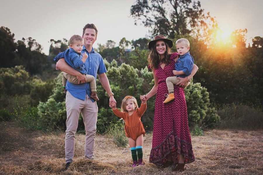 Man and wife who spent two years in therapy hold hands with daughter while each hold twin boys