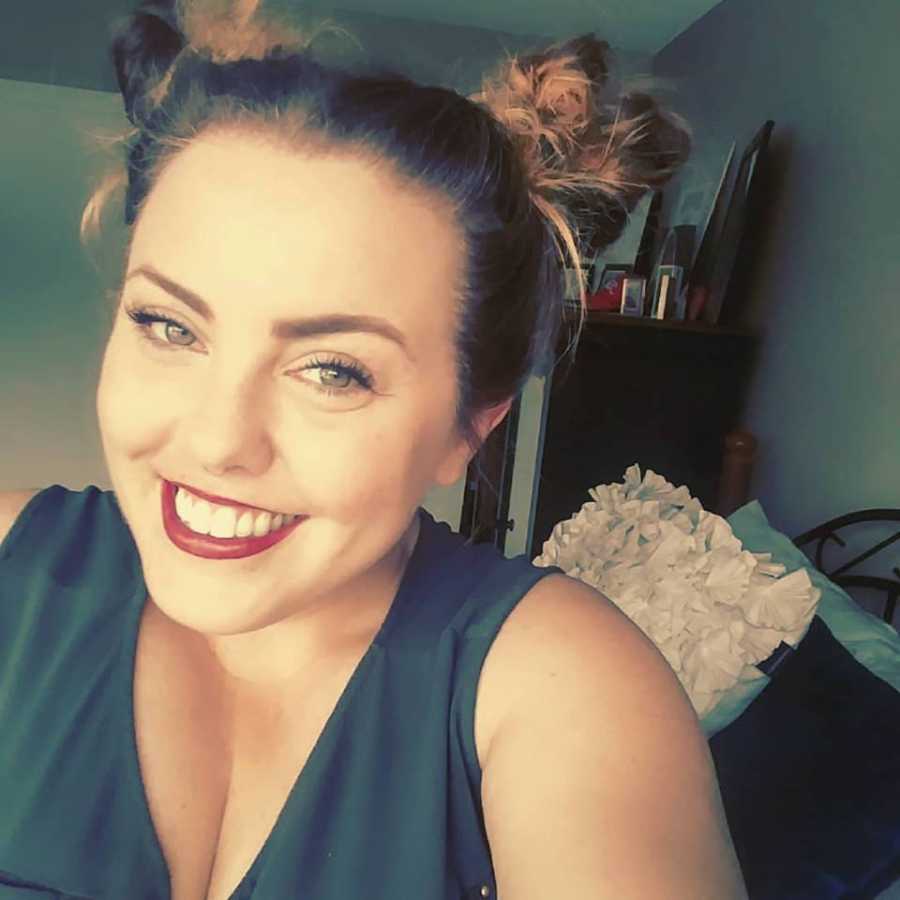 Woman who was once an alcoholic and stole money from her sister smiling in selfie sober