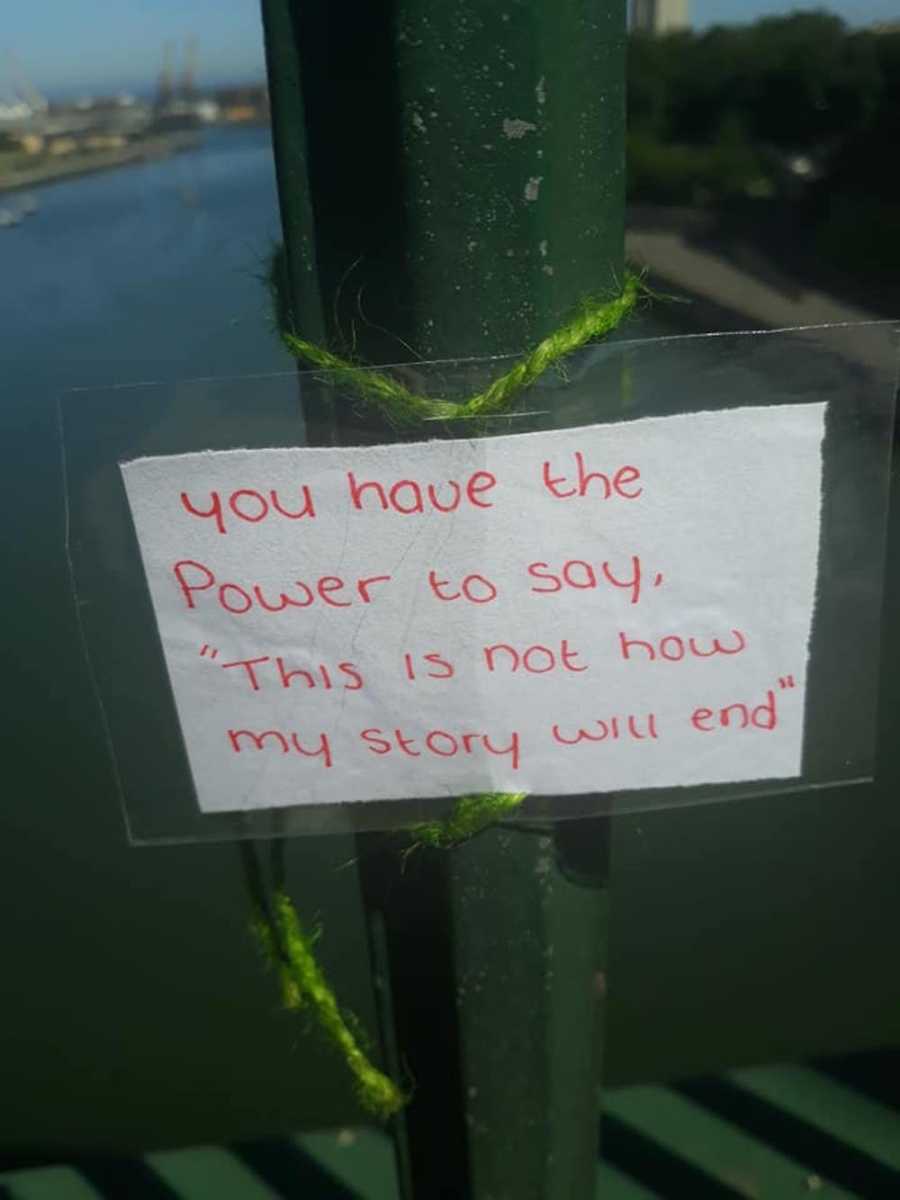 Note on bridge reads "you have the power to say, 'This is not how my story will end."