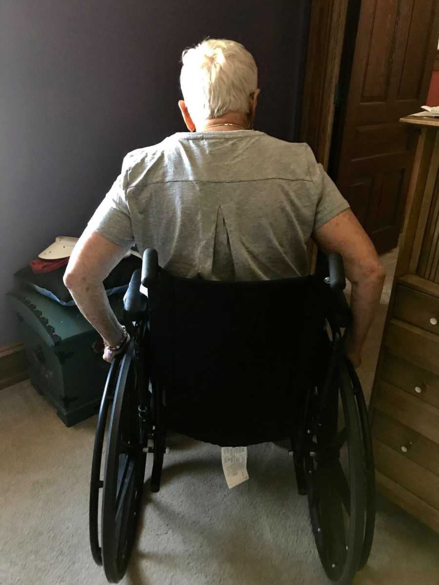 Elderly woman battling dementia rolls herself around her house in her wheelchair