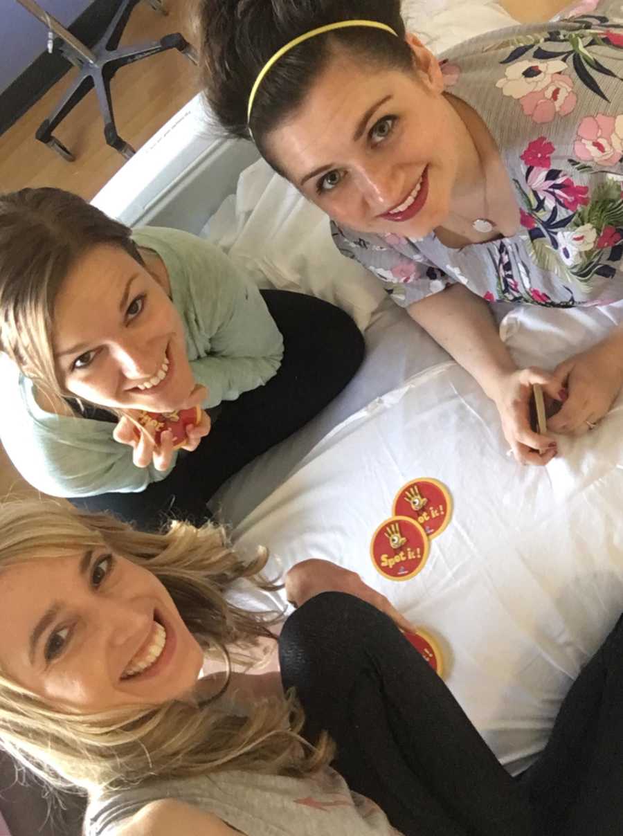 Woman with pandysautonomia smiles in selfie in hospital bed after being rushed to ER with two other women