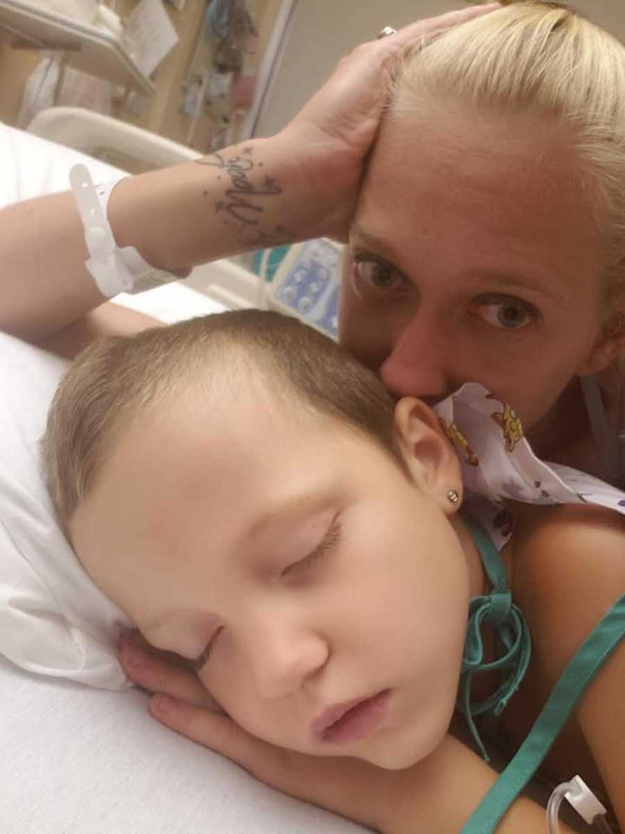 Mother lays behind young son in hospital bed after mosquito bite in selfie