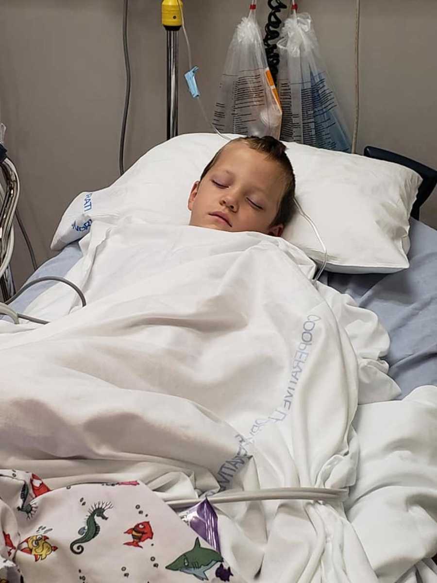 Little boy lying in hospital bed from mosquito bite