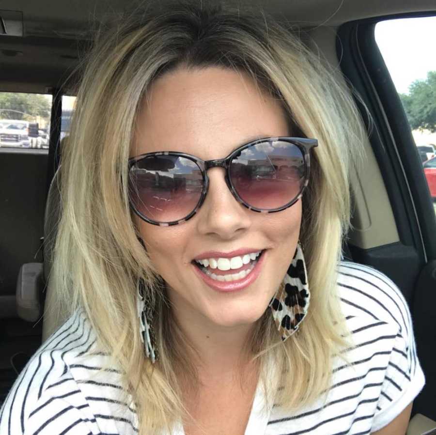 Woman who opens up about anxiety struggles smiles in selfie in her car