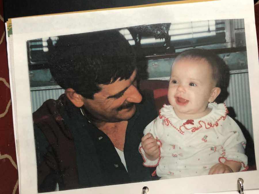 Daughter who surprised her mother with tattoo sitting on her grandfather's lap as a baby