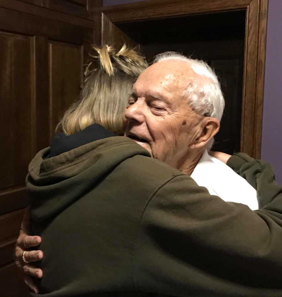 Teen who is going to college in another country hugs grandfather goodbye