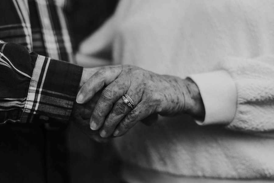 Close up of elderly wife with dialysis and husband holding hands