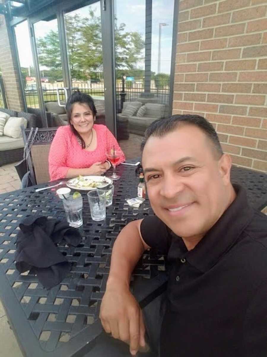 Husband and wife who gave up their child for adoption as teens smile in selfie at restaurant table